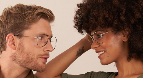 Man and woman wearing glasses working 
